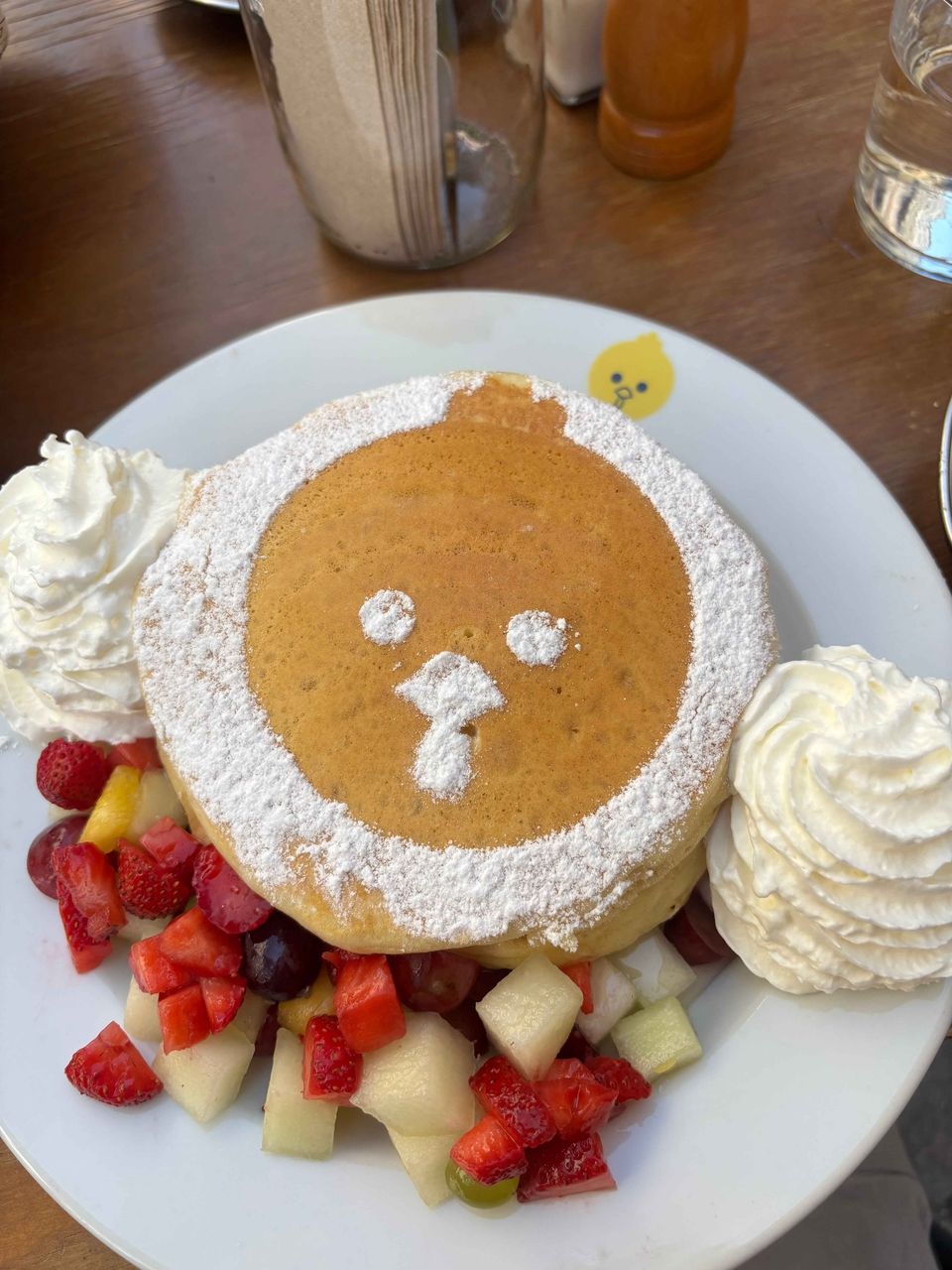 Billy the Chicken's face in powdered sugar on my pancake.