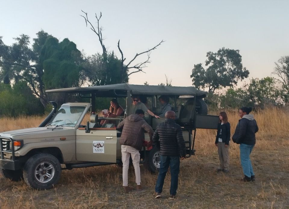 Dr. G. (center) and Dr. Matsika (right) preparing to load back into our safari vehicle after fixing a flat tire in the Okavango Delta