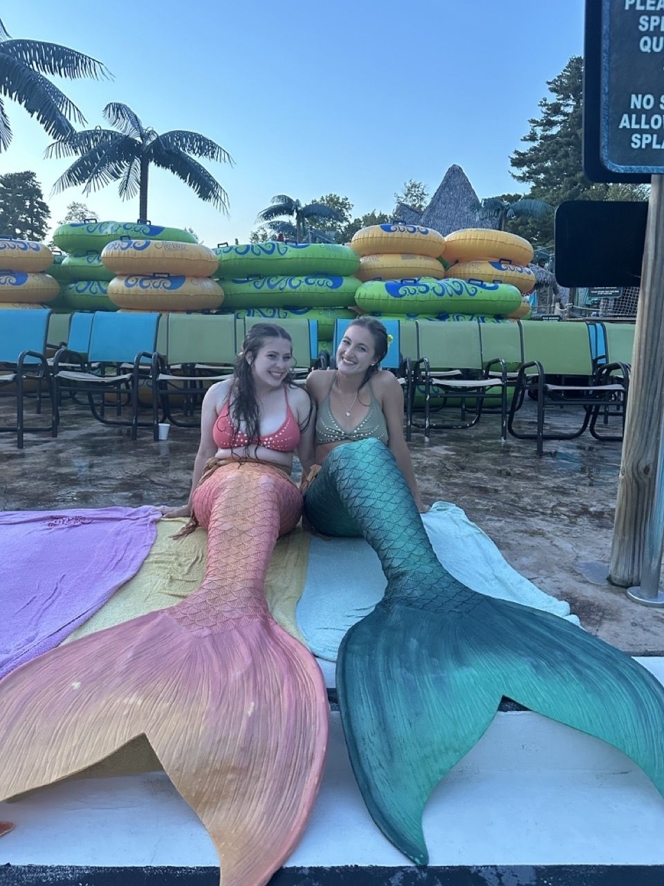 Two mermaids by the pool