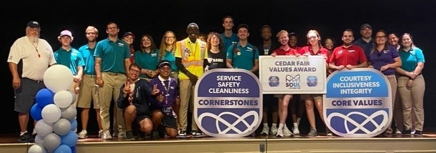 Elijah poses with many of his Cedar Point coworkers.
