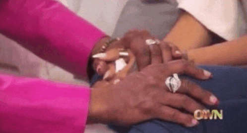 Screen grab from a TV show where host Iyanla Vanzant holds hands with her client in preparation to share harsh yet encouraging truths