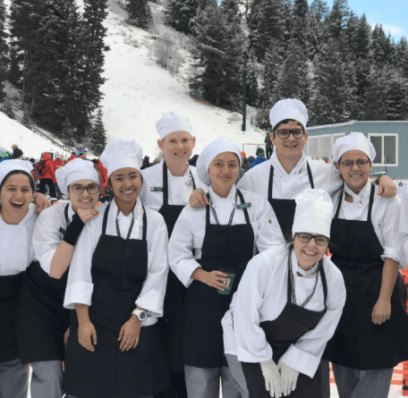 Participants from Deer Valley Resort Empire Canyon Lodge in Park City, Utah, pose together.