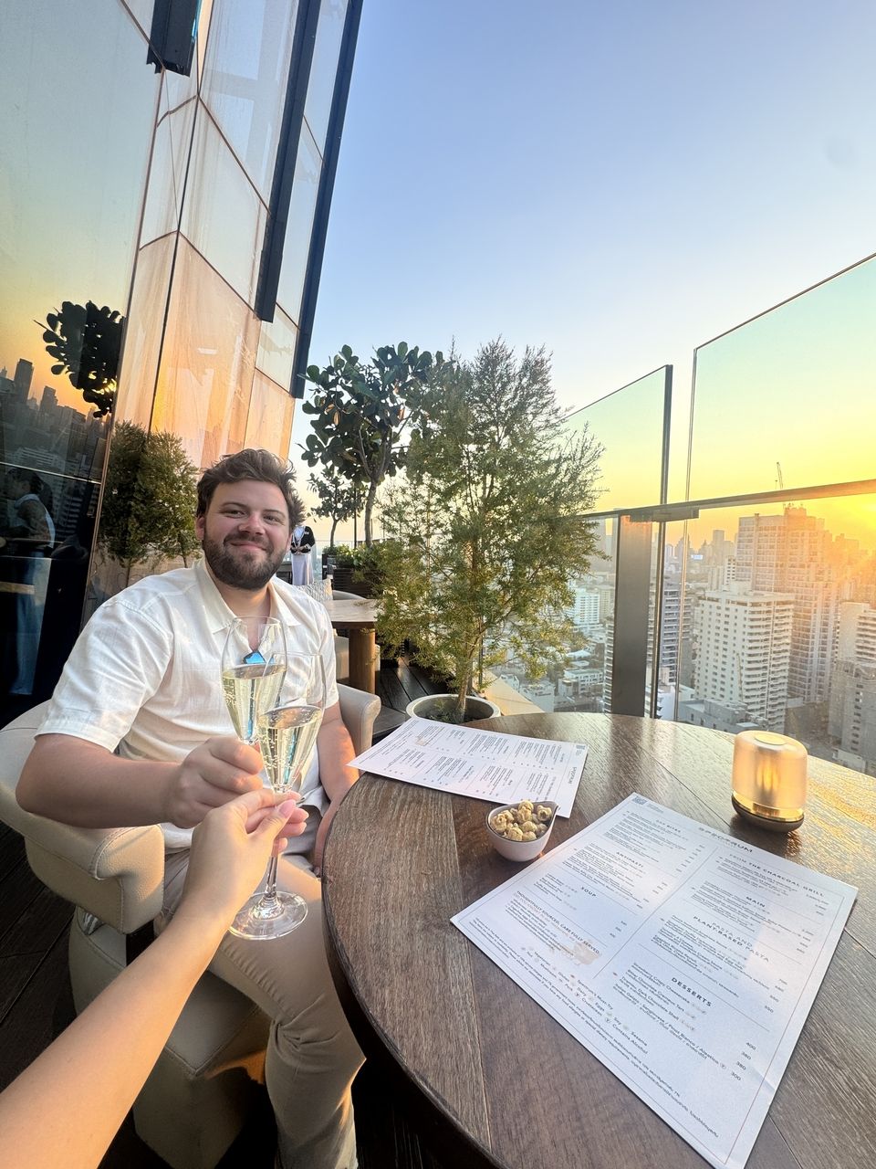 Sharing champagne at a rooftop bar in Bangkok