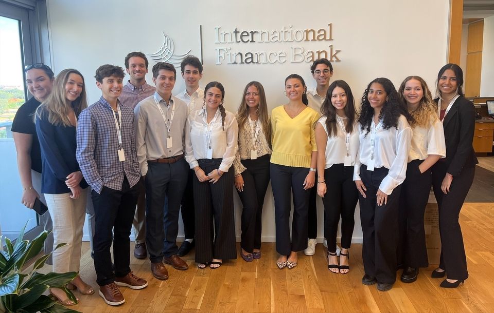 Pierre Henri P. of France, sixth from left, poses with his coworkers at International Finance Bank in Miami, Florida. He served as a risk management intern with CIEE BridgeUSA.
