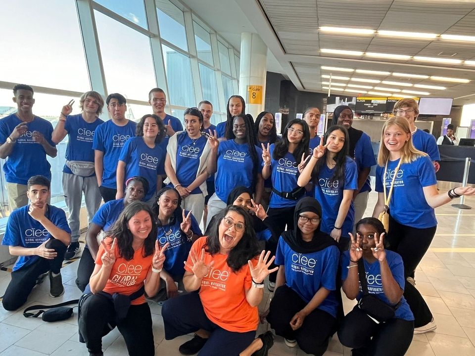 Group of high school summer program leaders posing at the airport