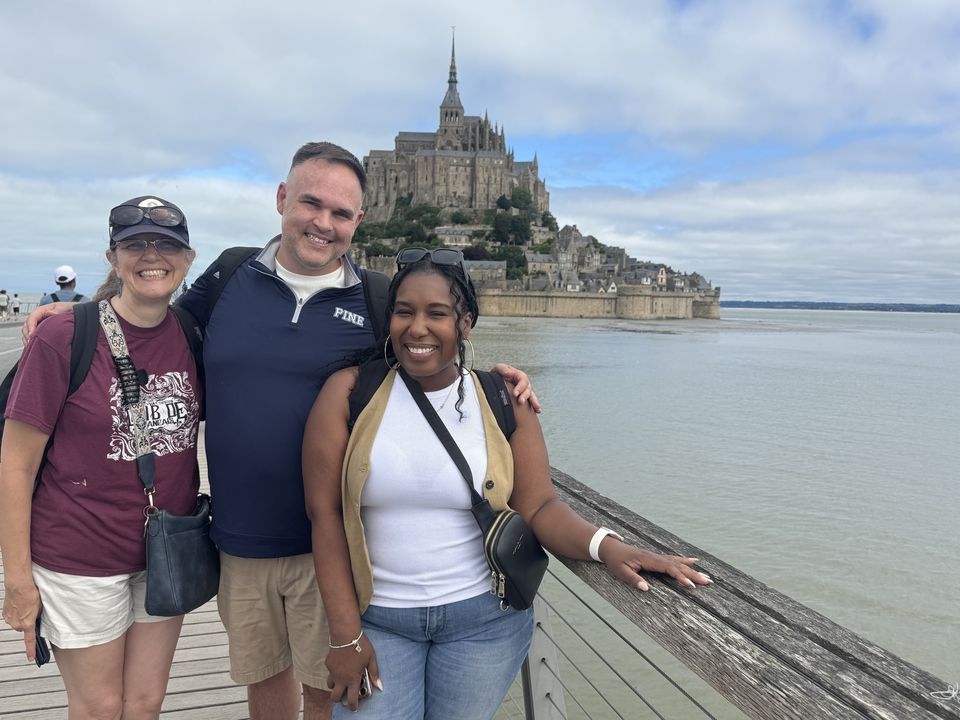 Program leaders on excursion with castle behind them