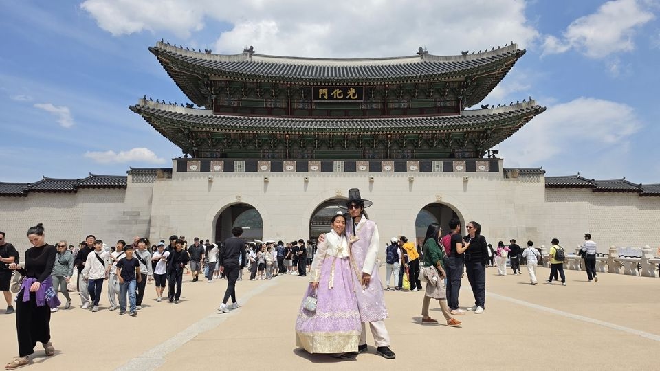Infront Gyeongbokgung Palace with matching Hanboks