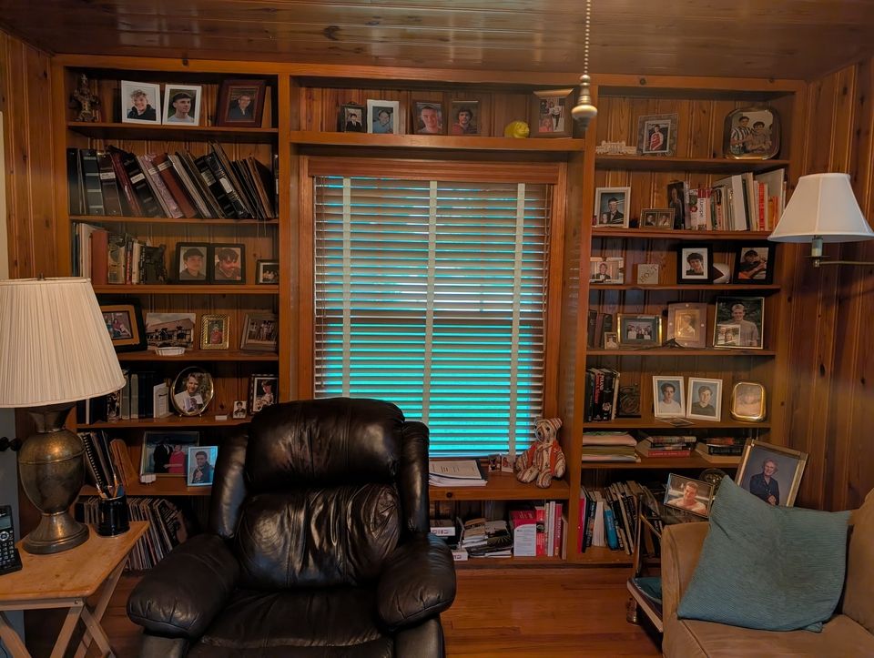 Dave Clark keeps photos of all 28 of his exchange students on the wall.
