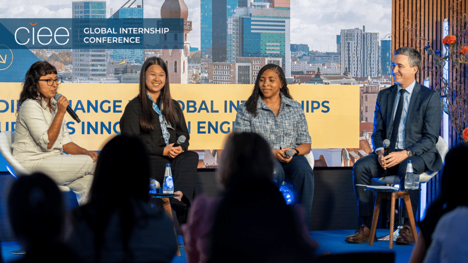 Three former CIEE paid global interns participate in a panel discussion with Patrick Moran at the 14th Annual Global Internship Conference, sharing reflections on career growth and access to international internships.