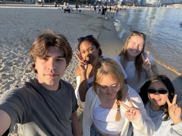 5 friends taking a selfie on a beach