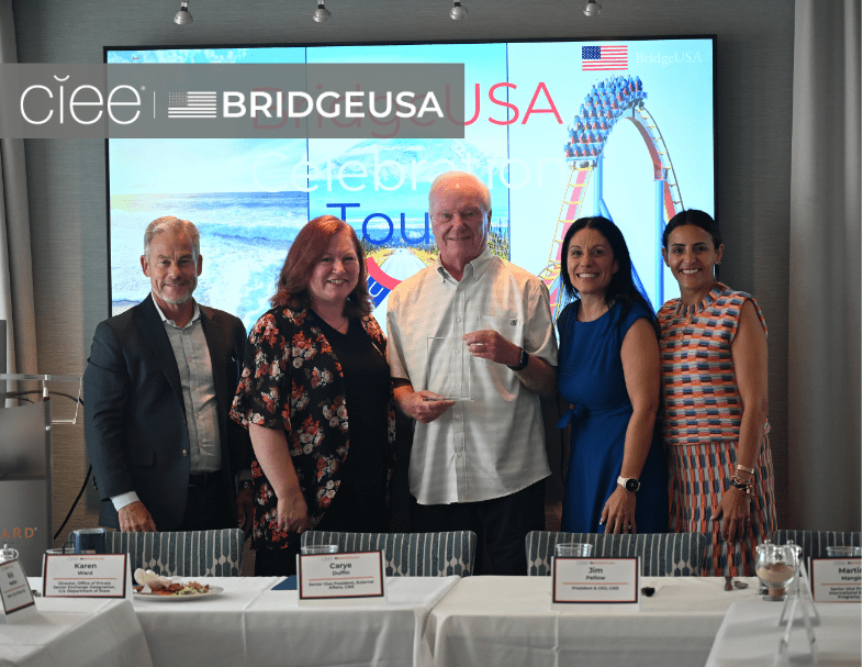 CIEE and BridgeUSA representatives pose with an award recipient during a BridgeUSA Celebration Tour event.