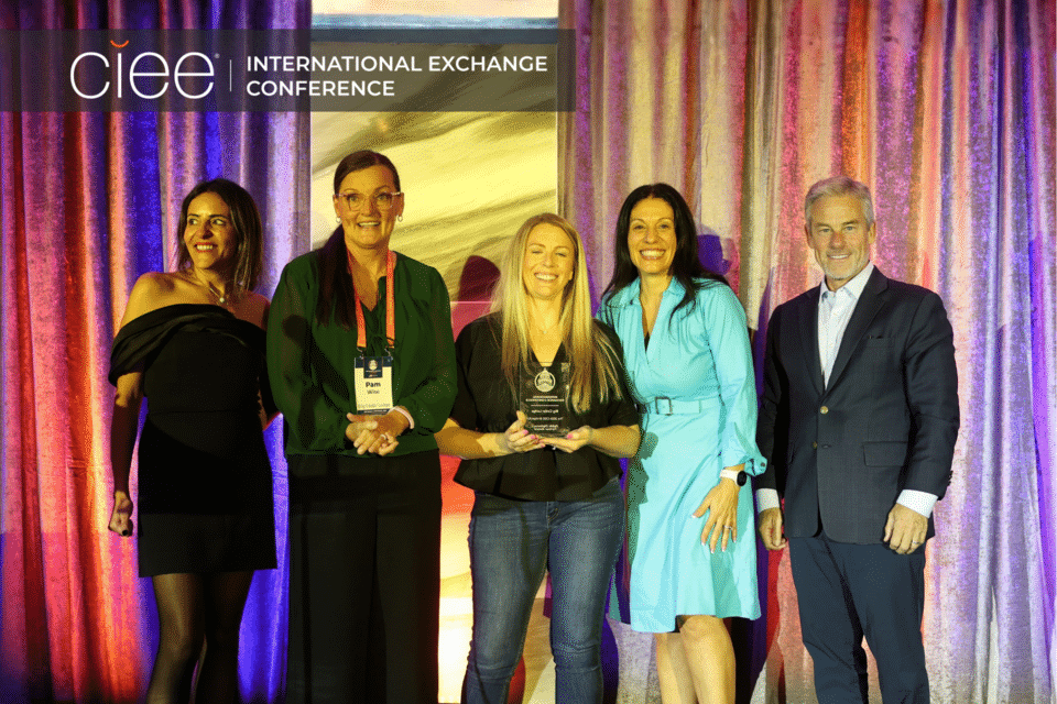 Award winners pose on stage accepting their awards