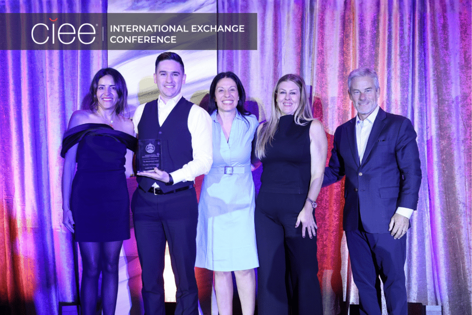 Award winners pose on stage accepting their awards