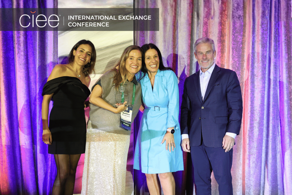 Award winners pose on stage accepting their awards