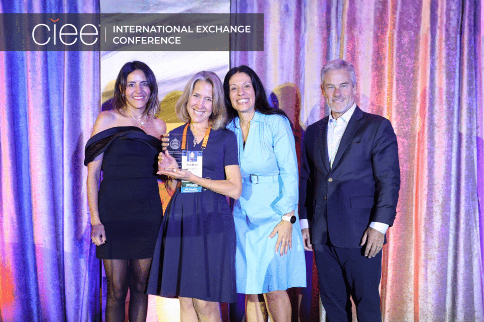 Award winners pose on stage accepting their awards