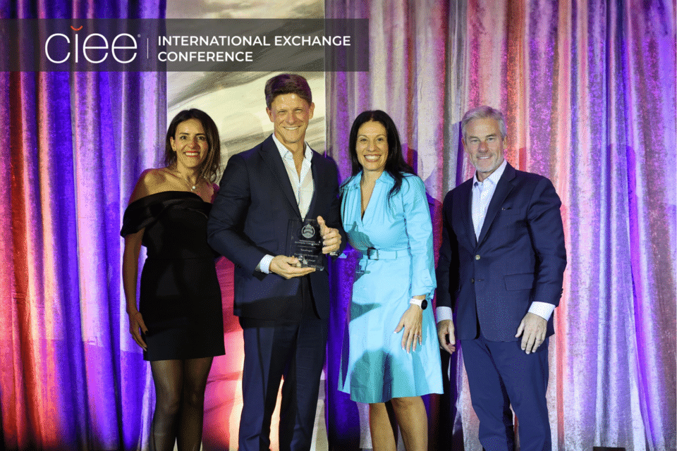 Award winners pose on stage accepting their awards