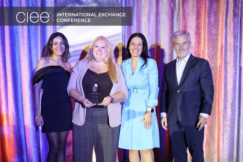 Award winners pose on stage accepting their awards