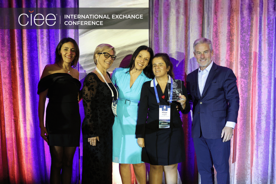 Award winners pose on stage accepting their awards