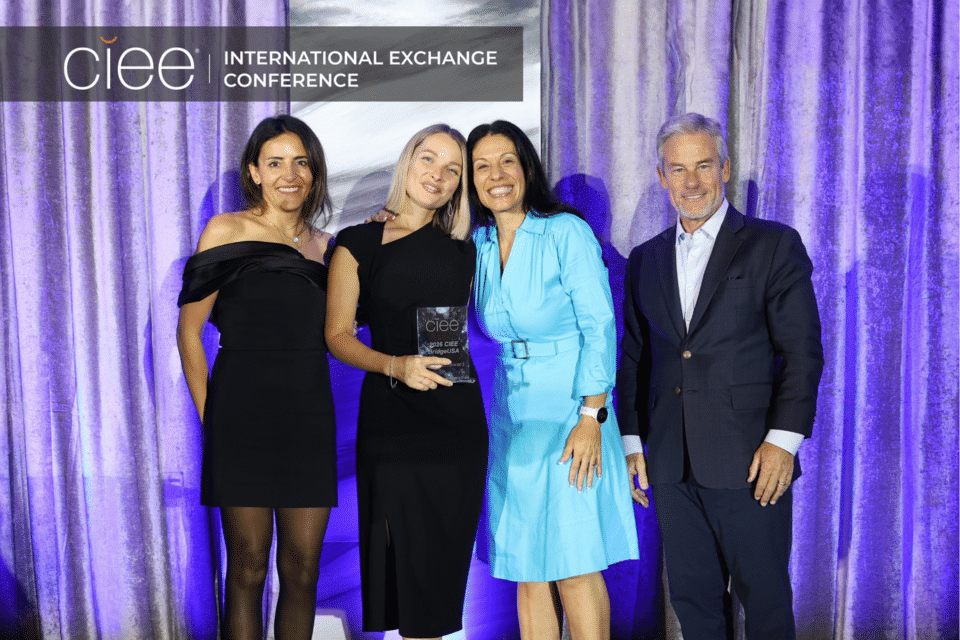 Award winners pose on stage accepting their awards