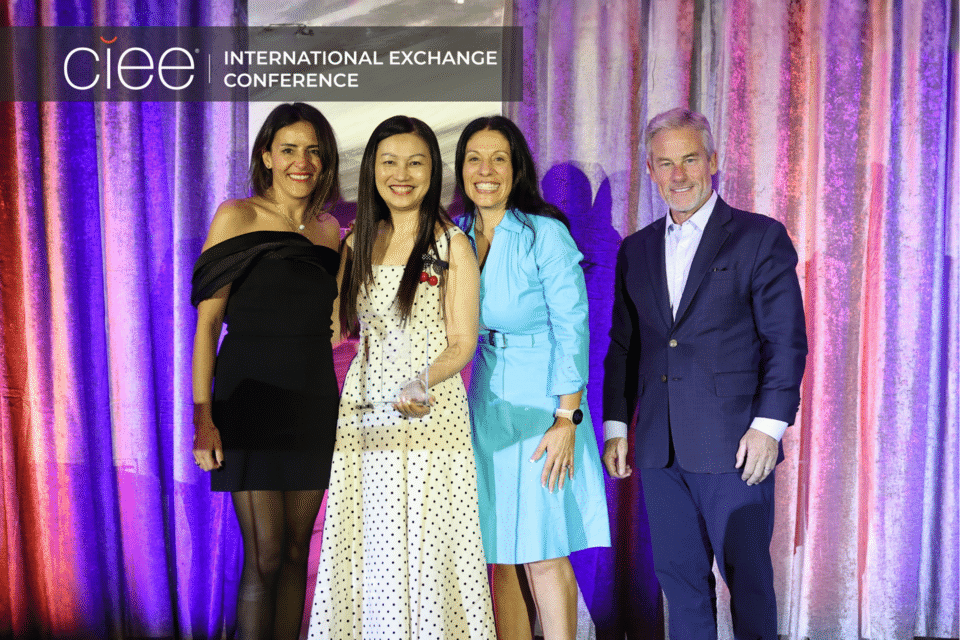 Award winners pose on stage accepting their awards