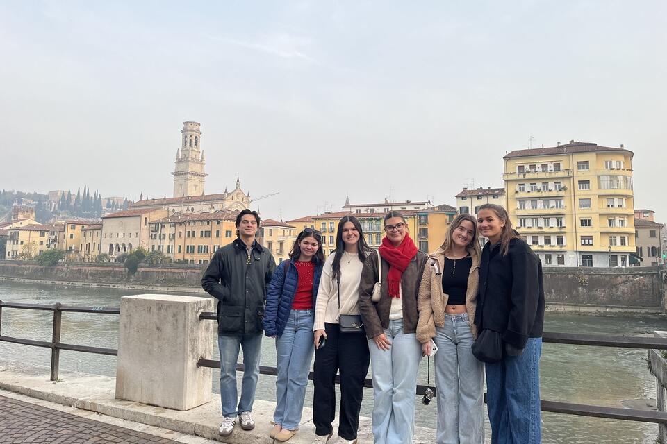 Students posing on bridge in Italy