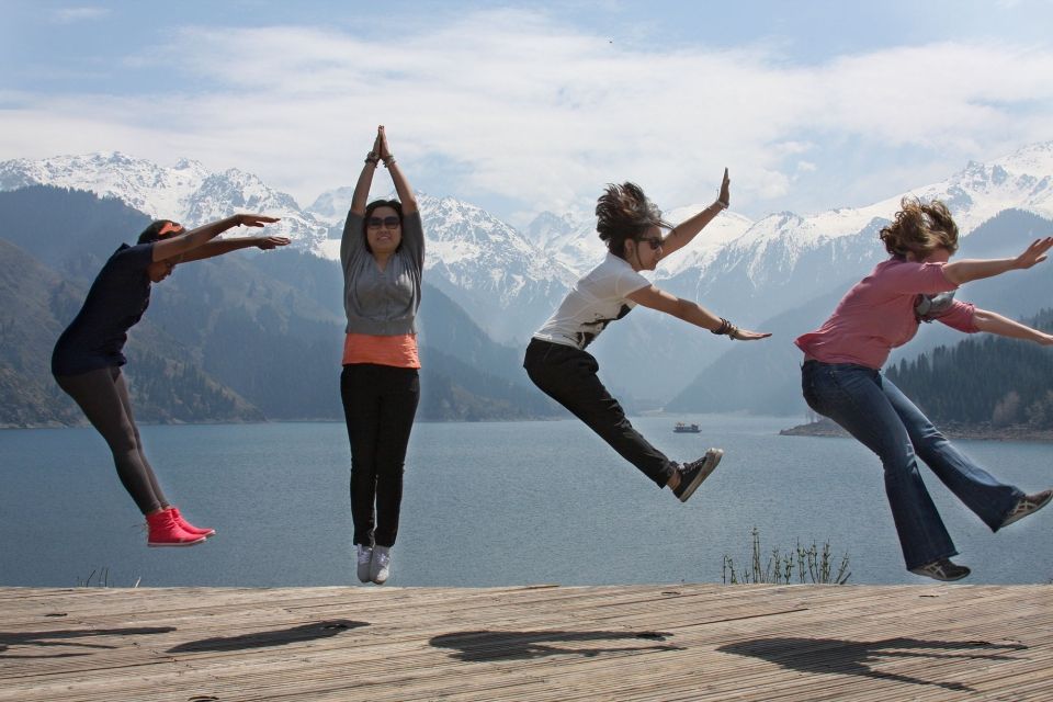 Girls jumping by lake