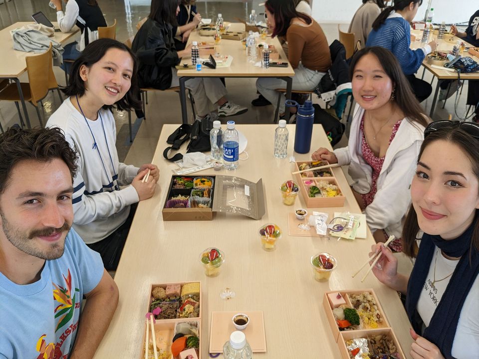 Young people eating sushi at a table in Japan