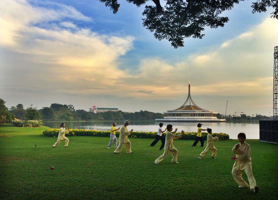 People in Thailand exercising on a lawn