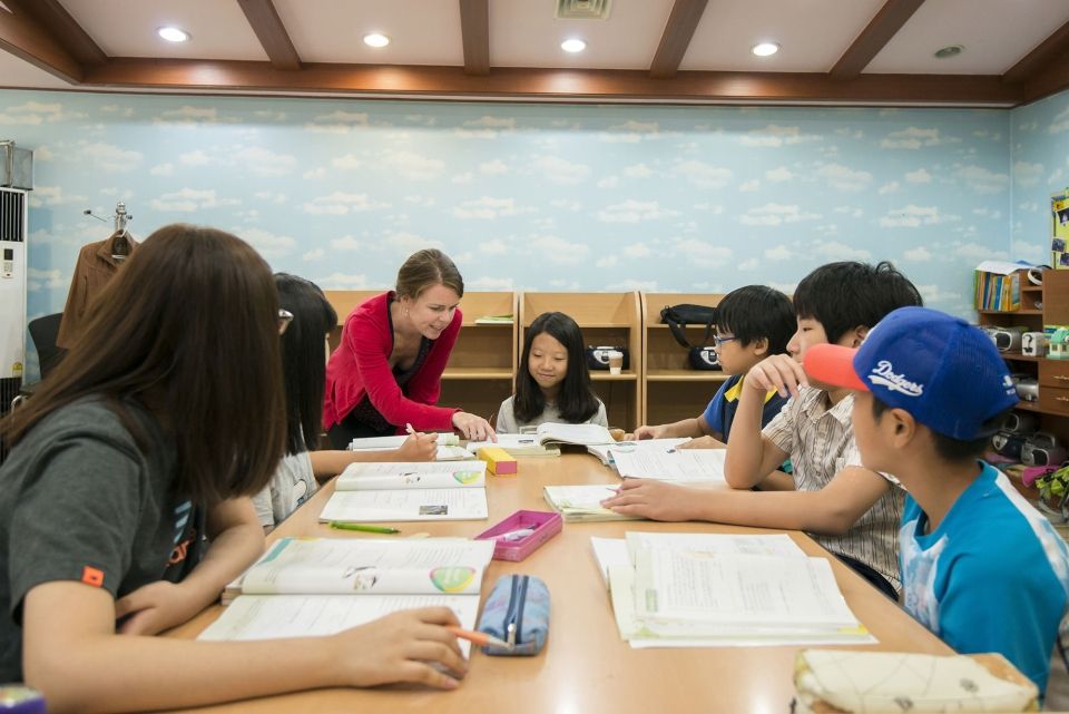 Teacher helping student in South Korean classroom