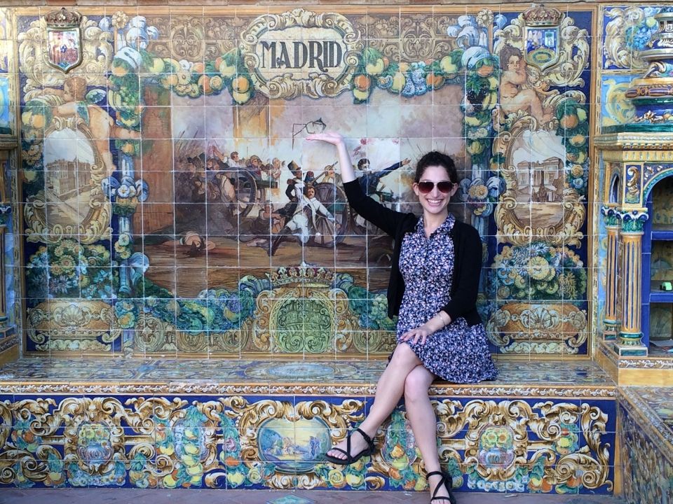 Woman sitting on beautiful tiled bench in Madrid