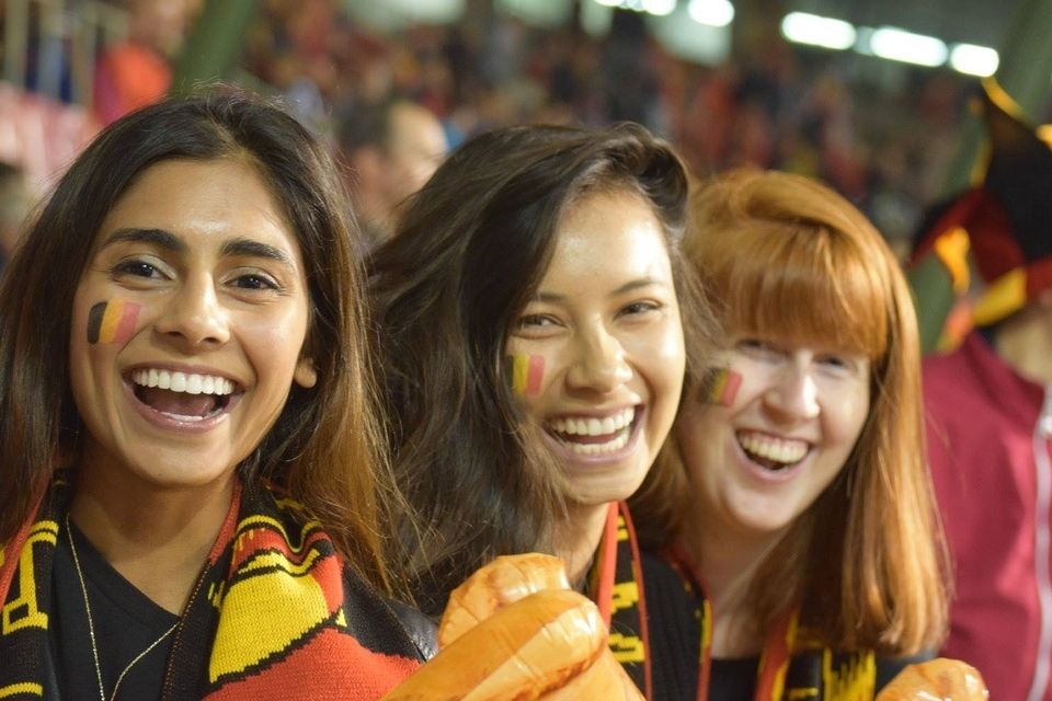 Female students root for Belgium during soccer game in Brussels