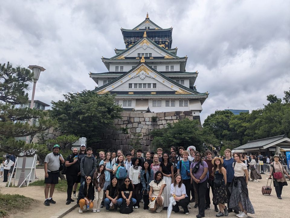 Students pose in front of temple during overnight trip